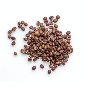 brown coffee beans on white surface